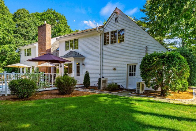 34 Marla Ln, Hatchville, MA 02536 - back of property with a yard, a chimney, and a cooling unit
