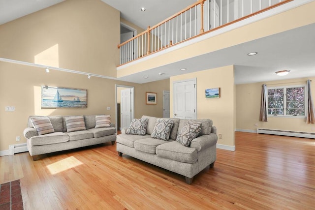 34 Marla Ln, Hatchville, MA 02536 - living area with baseboard heating, a towering ceiling, wood finished floors, baseboards, and recessed lighting