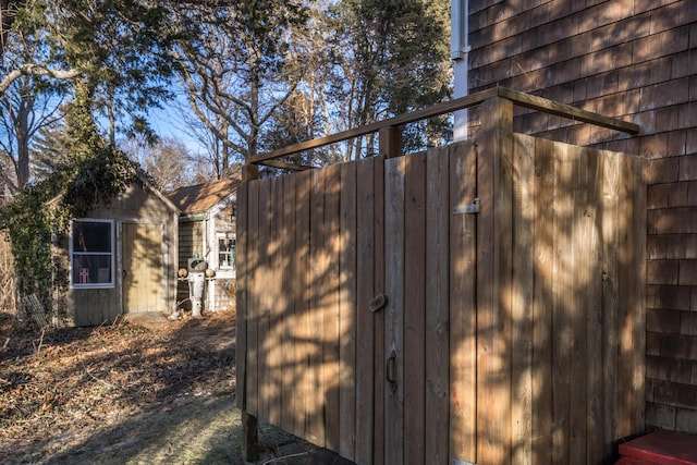 exterior space featuring a storage shed and an outbuilding