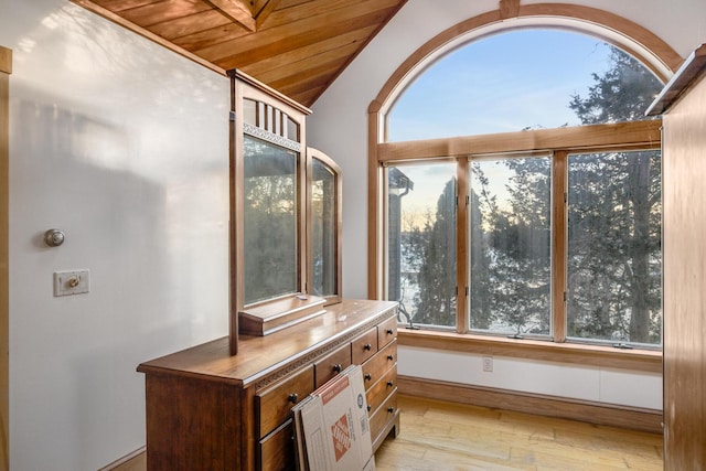 sunroom / solarium featuring wood ceiling, vaulted ceiling, and a wealth of natural light