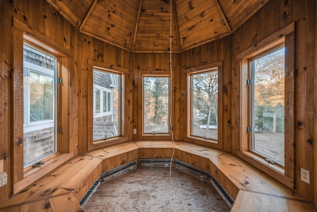 unfurnished sunroom featuring vaulted ceiling and wooden ceiling