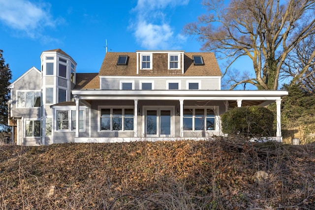 rear view of property featuring a shingled roof