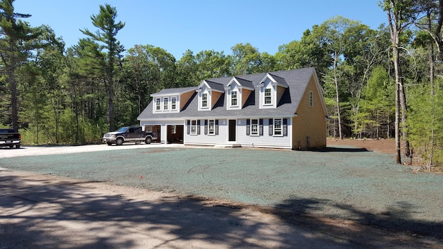 new england style home with a front lawn