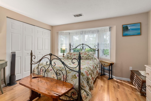 bedroom with a closet and light hardwood / wood-style floors