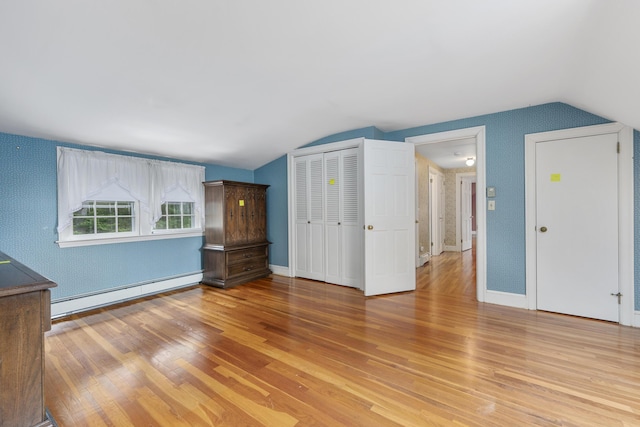 105 Rolling Hitch Rd, Centerville, MA 02632 - interior space featuring a baseboard radiator, light wood-style floors, lofted ceiling, and baseboards