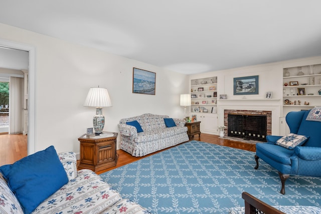 105 Rolling Hitch Rd, Centerville, MA 02632 - living room with a fireplace, wood finished floors, and built in features