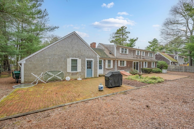 105 Rolling Hitch Rd, Centerville, MA 02632 - back of house with a patio area, a chimney, and fence