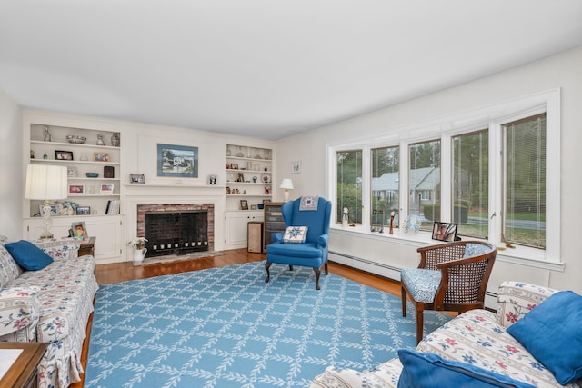 105 Rolling Hitch Rd, Centerville, MA 02632 - living area featuring a fireplace, wood finished floors, and baseboard heating