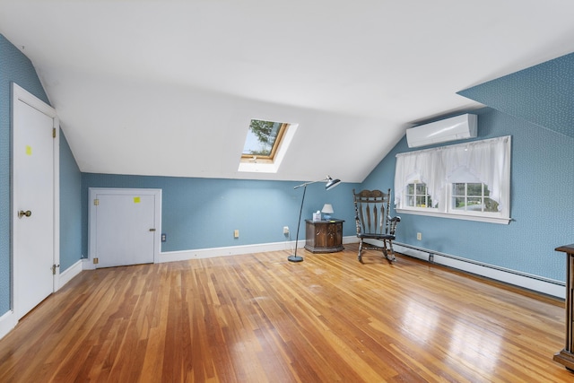 105 Rolling Hitch Rd, Centerville, MA 02632 - additional living space with a wall mounted air conditioner, lofted ceiling with skylight, baseboards, a baseboard radiator, and hardwood / wood-style flooring