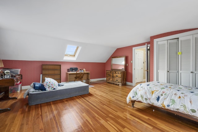 105 Rolling Hitch Rd, Centerville, MA 02632 - bedroom with wood-type flooring, baseboards, vaulted ceiling with skylight, and a closet