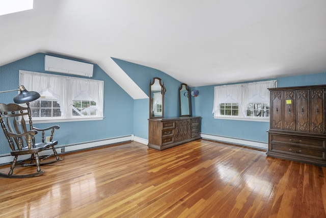 105 Rolling Hitch Rd, Centerville, MA 02632 - interior space featuring wood finished floors, vaulted ceiling, baseboards, a baseboard radiator, and a wall mounted AC