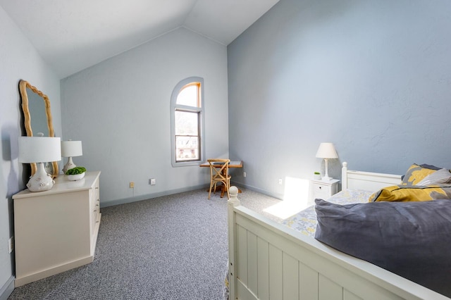 carpeted bedroom with baseboards and lofted ceiling