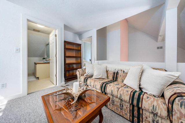 living room featuring visible vents, carpet, baseboards, and vaulted ceiling