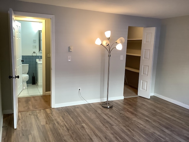 interior space featuring hardwood / wood-style floors and tile walls