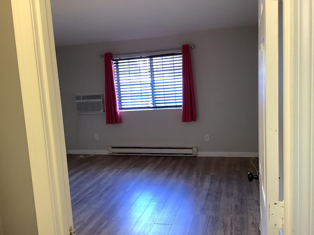 empty room featuring baseboard heating, dark hardwood / wood-style floors, and a wall mounted AC