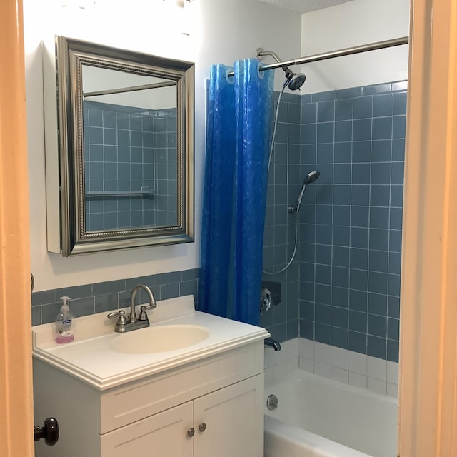 bathroom with vanity and shower / tub combo with curtain