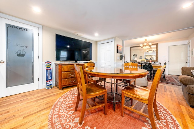 dining area with a chandelier, light wood-type flooring, and recessed lighting
