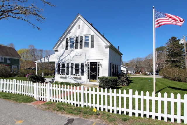 view of front of house with a front yard and a fenced front yard