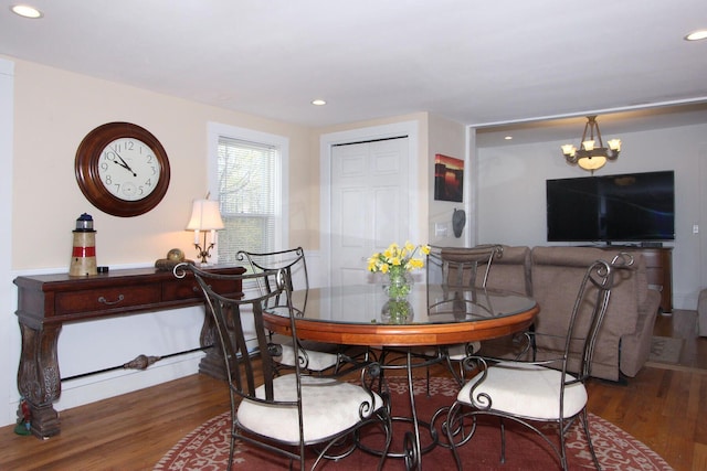 dining room with an inviting chandelier, wood finished floors, and recessed lighting