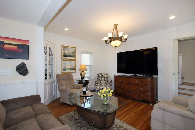 living area with wood finished floors, recessed lighting, and a notable chandelier