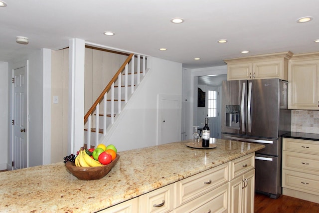 kitchen featuring stainless steel fridge with ice dispenser, recessed lighting, and cream cabinets