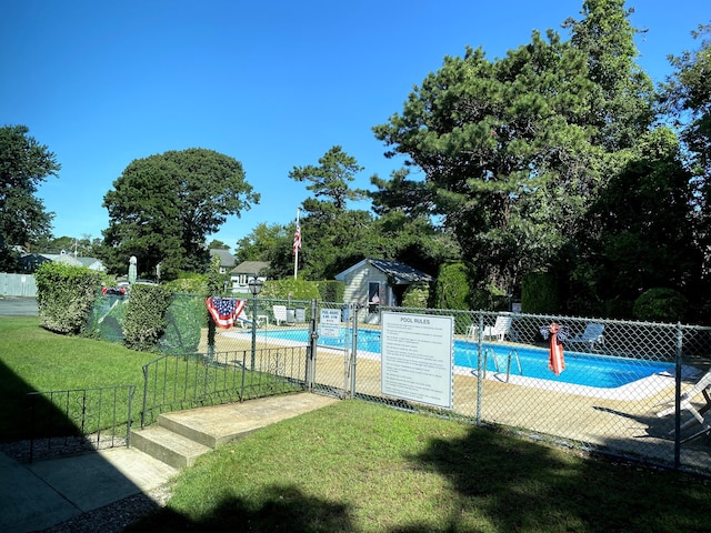 view of pool featuring a yard