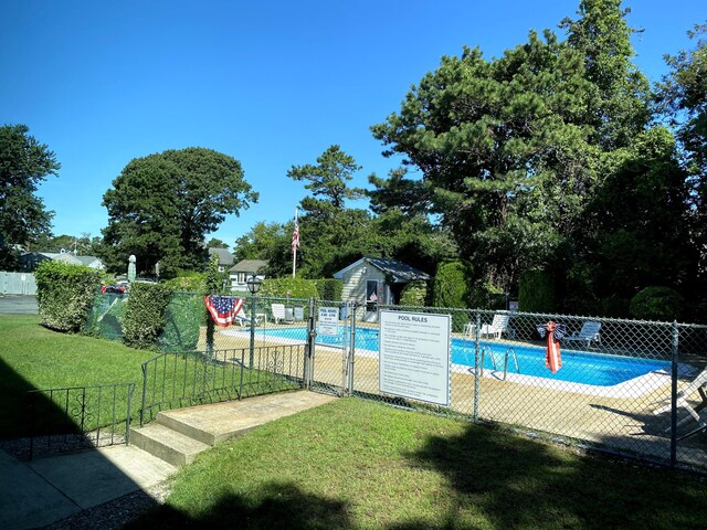 view of pool featuring a yard