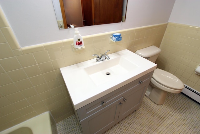 bathroom with vanity, toilet, tile walls, and tile patterned flooring