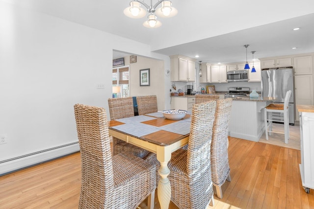 dining area featuring recessed lighting, a notable chandelier, light wood-style flooring, and baseboard heating