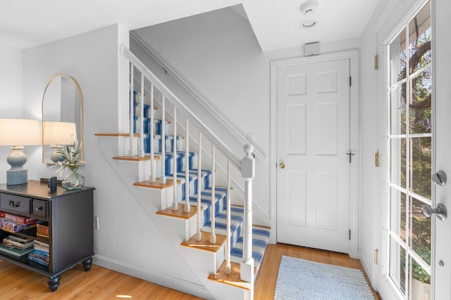 stairs with baseboards and wood finished floors