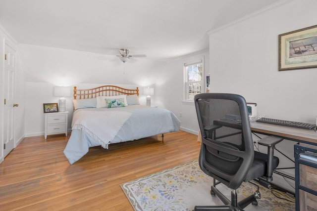 bedroom with light wood finished floors, a ceiling fan, baseboards, and crown molding