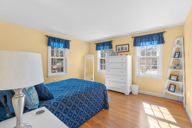 bedroom with baseboards and wood finished floors