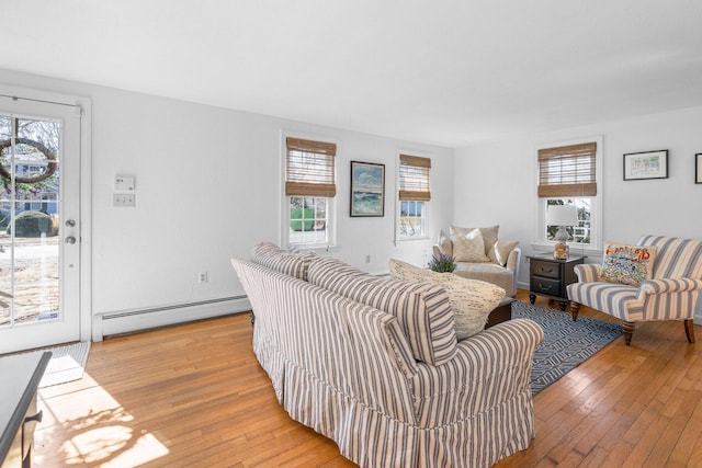 living area with a baseboard radiator and light wood-style flooring