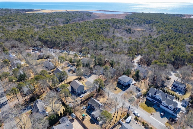 drone / aerial view with a water view and a view of trees