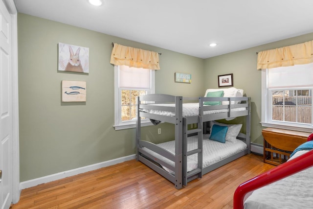 bedroom featuring recessed lighting, wood-type flooring, and baseboards