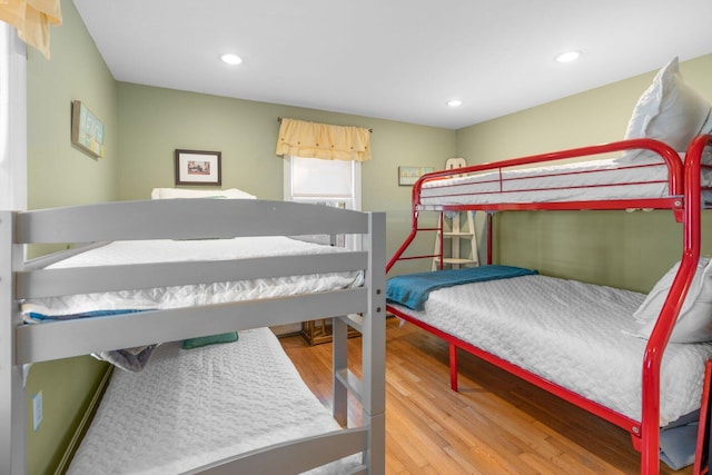 bedroom with recessed lighting and wood finished floors