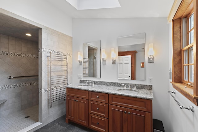 bathroom with double vanity, radiator heating unit, a walk in shower, and a sink