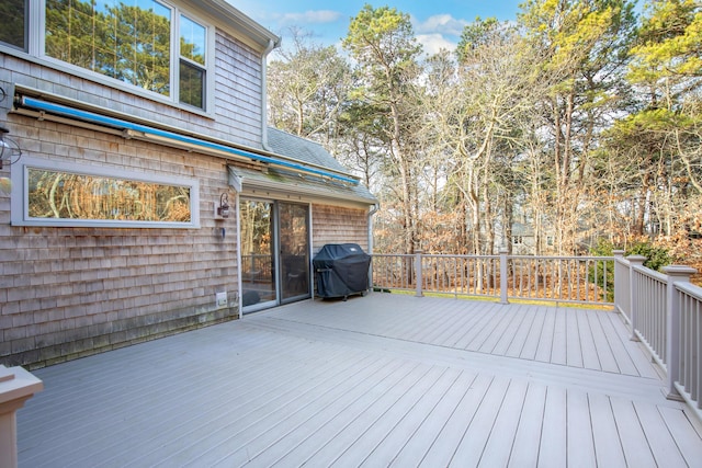 wooden deck featuring a grill