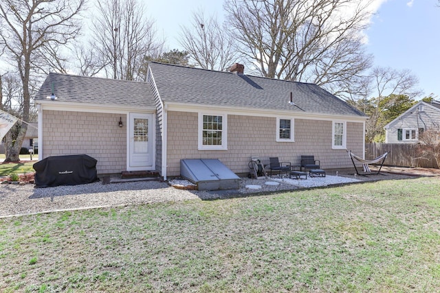 16 Samoset Rd, South Yarmouth, MA 02664 - back of house featuring a shingled roof, a lawn, a chimney, fence, and a patio