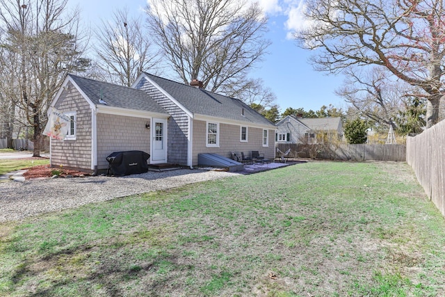16 Samoset Rd, South Yarmouth, MA 02664 - back of house featuring roof with shingles, a yard, a fenced backyard, and a chimney