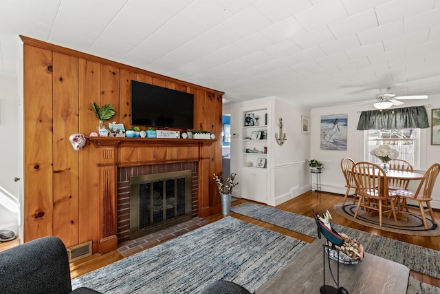 16 Samoset Rd, South Yarmouth, MA 02664 - dining room featuring a glass covered fireplace, wood-type flooring, and a ceiling fan