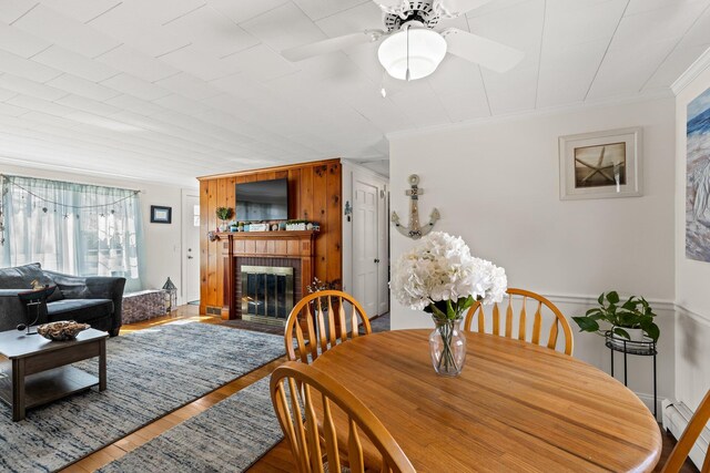 16 Samoset Rd, South Yarmouth, MA 02664 - dining area with wood finished floors, a brick fireplace, crown molding, and ceiling fan