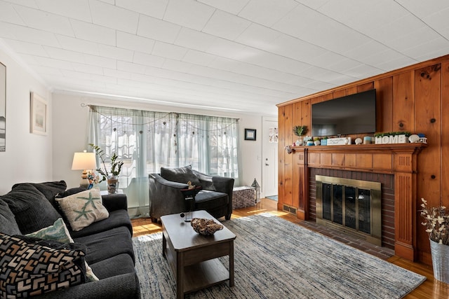 16 Samoset Rd, South Yarmouth, MA 02664 - kitchen with a baseboard heating unit, ornamental molding, light countertops, black appliances, and wood finished floors