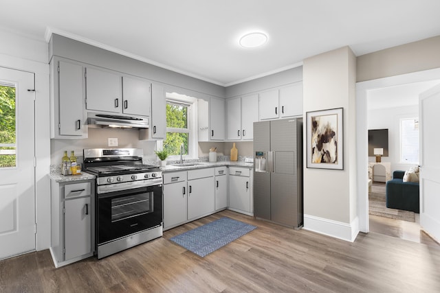 30 Terry Ct, Hyannis, MA 02601 - kitchen with gas stove, fridge with ice dispenser, under cabinet range hood, light wood-style flooring, and ornamental molding