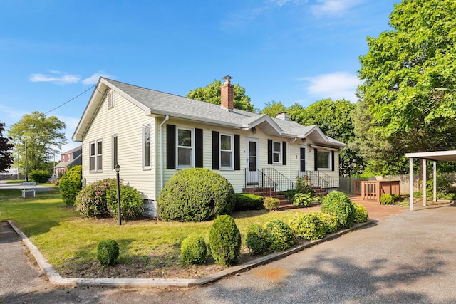30 Terry Ct, Hyannis, MA 02601 - view of front of house with a chimney, roof with shingles, and a front yard
