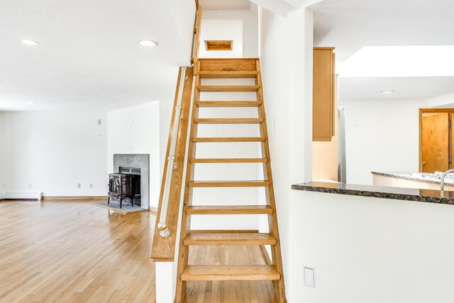 staircase featuring hardwood / wood-style flooring and baseboard heating