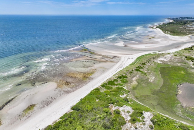 birds eye view of property with a water view and a view of the beach