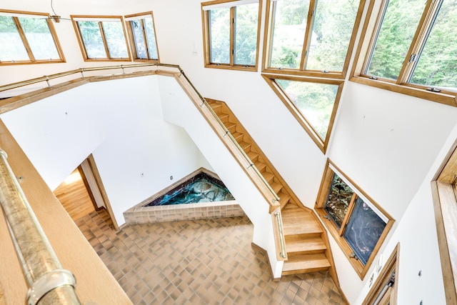 stairs featuring a high ceiling and plenty of natural light