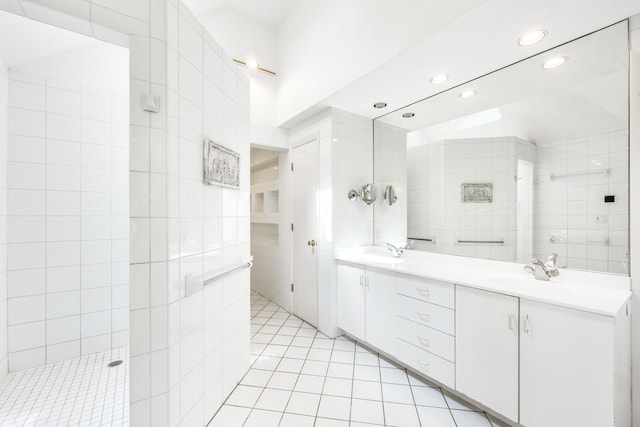 bathroom featuring vanity, tiled shower, tile walls, and tile patterned floors