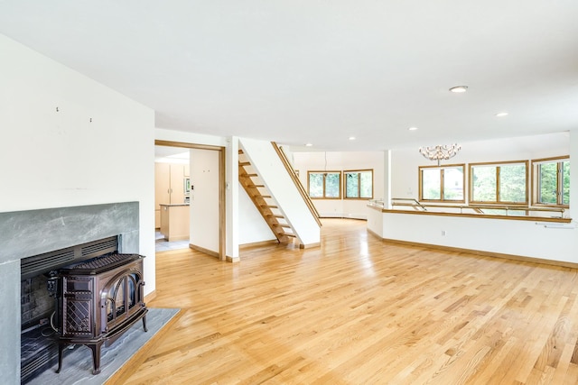 living room featuring light hardwood / wood-style flooring and a wood stove